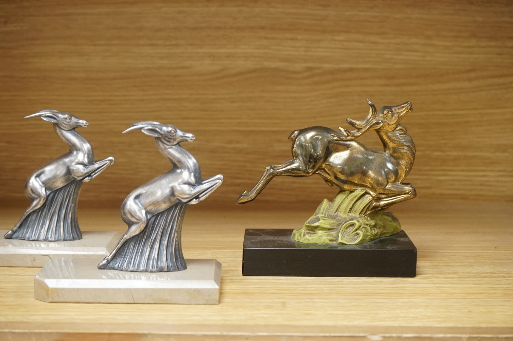 Two pairs of Art Deco bookends in the form of leaping animals, largest 14cm wide